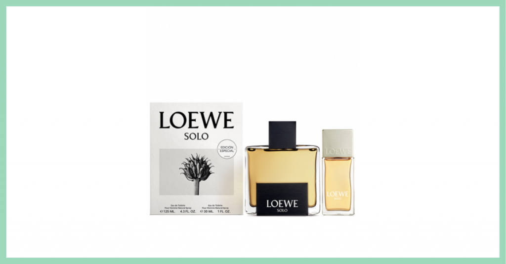 perfume grande y perfume pequeño Solo de la marca Loewe junto a una caja con el cartel oficial de la campaña que tiene una planta fotografiada en blanco y negro y el nombre de la marca arriba